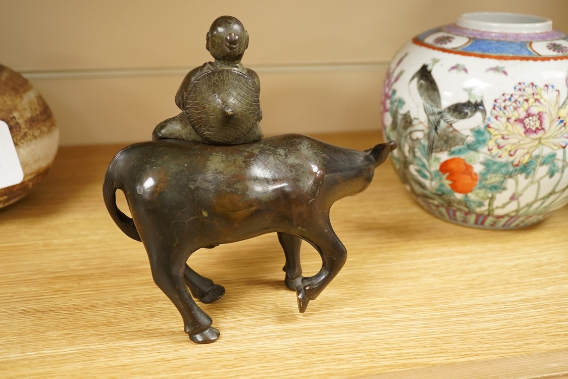 A Chinese bronze buffalo and figural incense burner, 18cm high